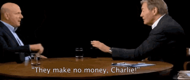 two men are sitting at a table with the words " they make no money charlie "