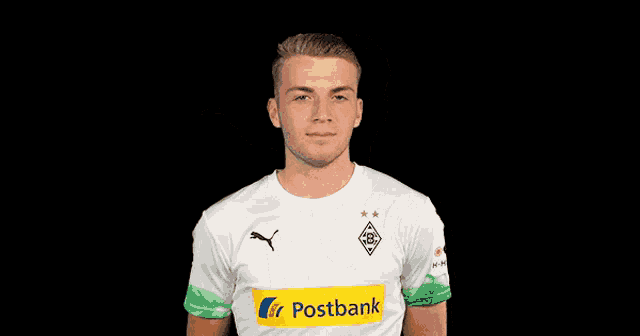 a soccer player wearing a white shirt with a postbank logo on the sleeve