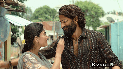a man with a beard and a woman are looking at each other .