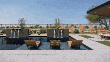 a swimming pool with a fence surrounding it and chairs in front of it