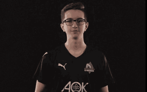 a young man wearing a black shirt with aok on it