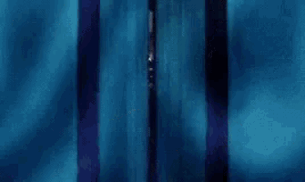 a man in a suit and tie is peeking out from behind a curtain .