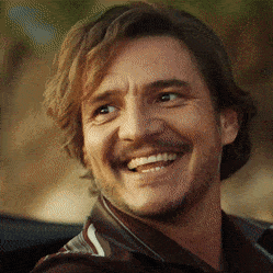 a close up of a man 's face with a beard smiling
