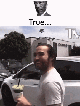 a man is standing in front of a white car holding a cup of coffee .