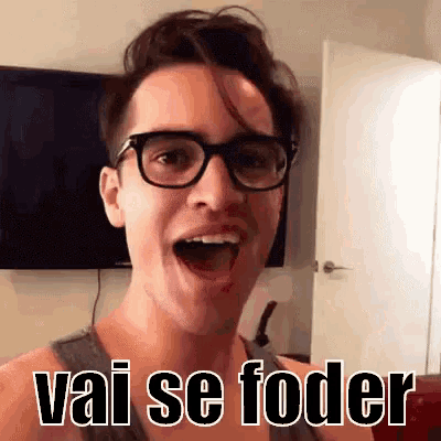a young man wearing glasses is making a funny face and says vai se foder .