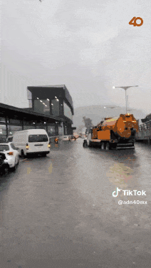 a truck is driving down a rainy street with the number 40 on the bottom right