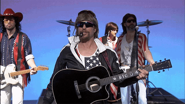 a man holding a guitar that says big d