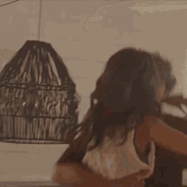 two women are hugging each other in a room .