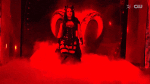 a woman in a devil costume with the name stephanie vaquer on a banner