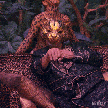 a leopard print couch with a person wearing a tiger mask