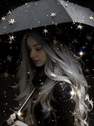 a woman holding a black umbrella with stars hanging from it