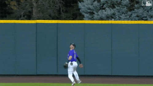 a baseball player wearing a purple jersey with the number 22 on it
