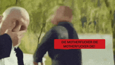 a bald man covering his face while another man says " die motherfucker die motherfucker die " in a red box