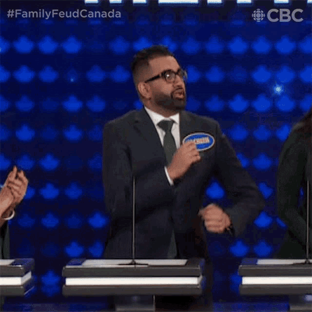 a man in a suit and tie is dancing on a television show .