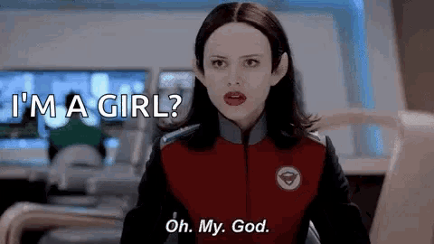 a woman in a red jacket is saying i 'm a girl and oh my god .
