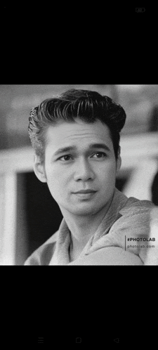 a black and white photo of a man 's face