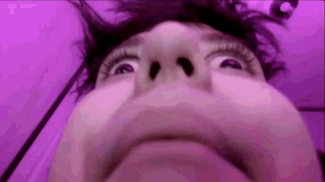 a close up of a person 's face making a funny face .