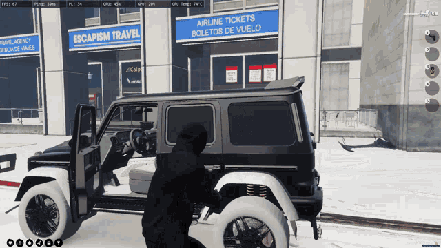 a man in a black hoodie is kneeling next to a black suv in front of a building that says escapism travel