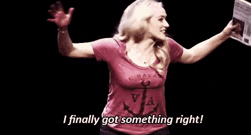 a woman in a pink t-shirt is holding a newspaper and says `` i finally got something right ! ''
