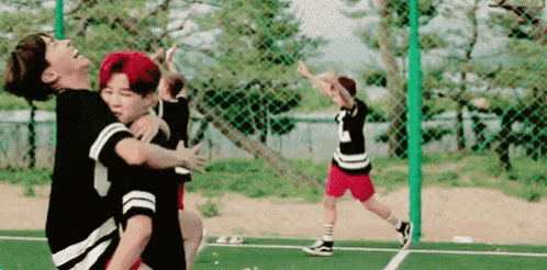 a group of boys are playing soccer on a field .