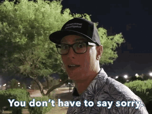 a man wearing a hat that says " paranormal investigator " on it