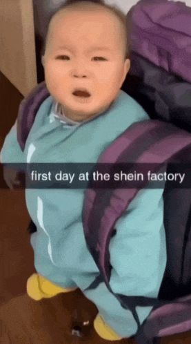 a baby is sitting in front of a purple backpack with the words first day at the shein factory on the bottom