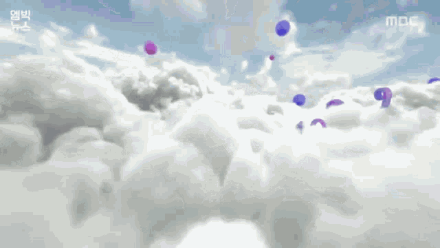 a purple number 10 is floating in the clouds