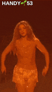 a woman is dancing on a stage with a handy 53 logo in the background
