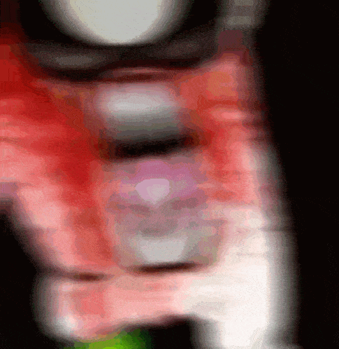 a blurred image of a person 's face with a red shirt on