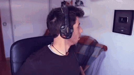 a man wearing a pair of bose headphones looks to the side