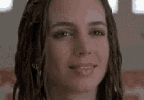 a close up of a woman 's face with dreadlocks .
