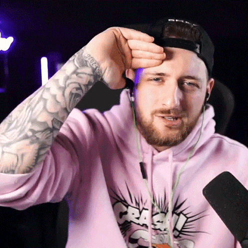 a man wearing a pink shirt that says crash
