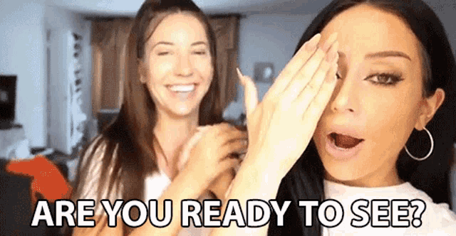 two women are covering their faces with their hands and laughing .