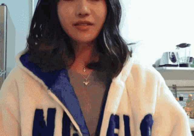 a woman is wearing a hoodie that says n.y.c.
