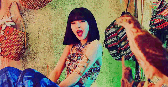 a woman is sitting on the floor with her mouth open in front of a wall surrounded by baskets .