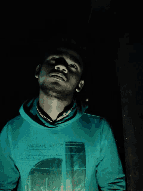 a man wearing a blue sweatshirt that says the final sketch
