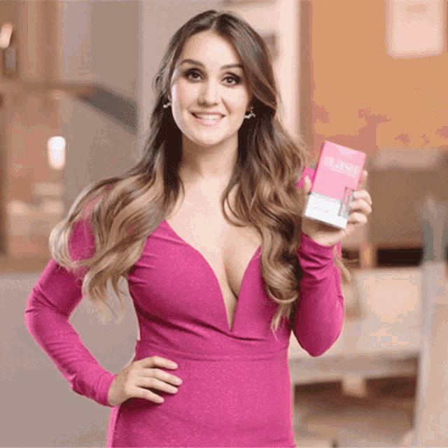 a woman in a pink dress is holding a box that says ' flexi ' on it