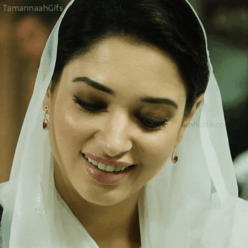 a close up of a woman 's face with the words tamannah gifs on the bottom