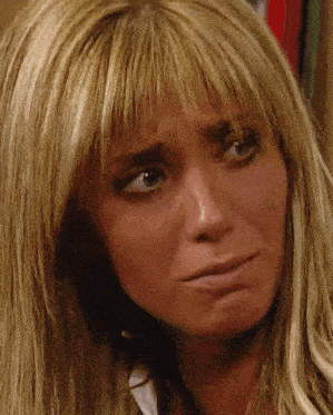 a woman with blonde hair is making a sad face
