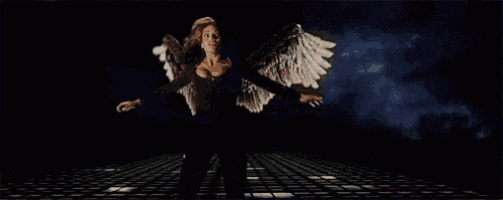 a woman with angel wings is standing on a tiled floor