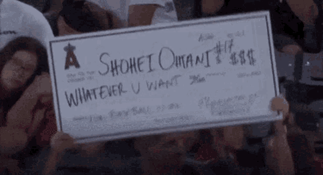 a person holding a check that says a shohei omani whatever u want