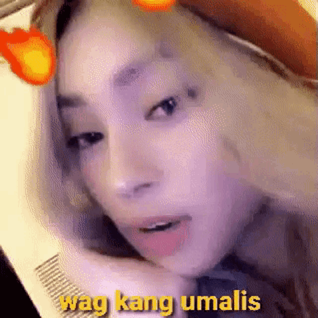 a close up of a woman 's face with a fire filter on her face .