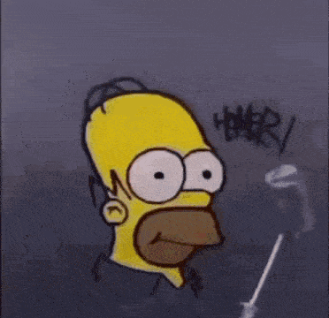 a person is holding a drawing of homer simpson 's face with big eyes .