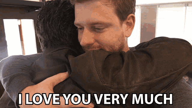 a man hugging another man with the words " i love you very much " on the bottom