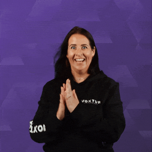 a woman wearing a black hoodie with the word voxtun on the sleeve