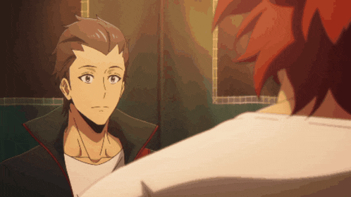 a man with red hair is looking at another man