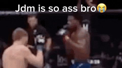 a blurry picture of two men fighting in a boxing ring with the caption `` jdm is so ass bro ''