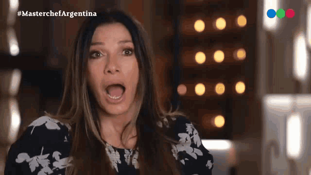 a woman in a black and white floral dress says " masterchef argentina " in the corner