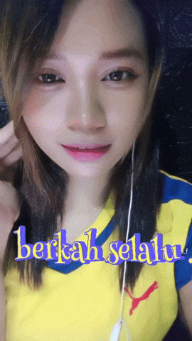 a girl wearing a yellow and blue shirt with the words berkah selalu written on it