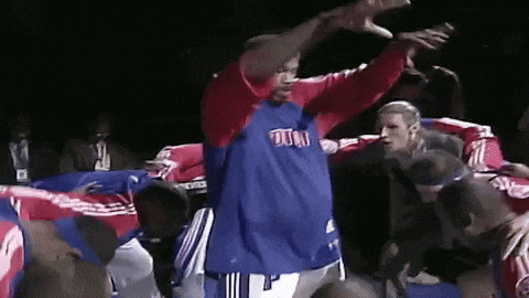 a man in a blue and red shirt with the word pistons on it